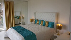 A bedroom with a large bed, a mirror, and two bedside lamps. - Luxurious contemporary villa with magnificent sea view Nice, Alpes-Maritimes, France (Nice)