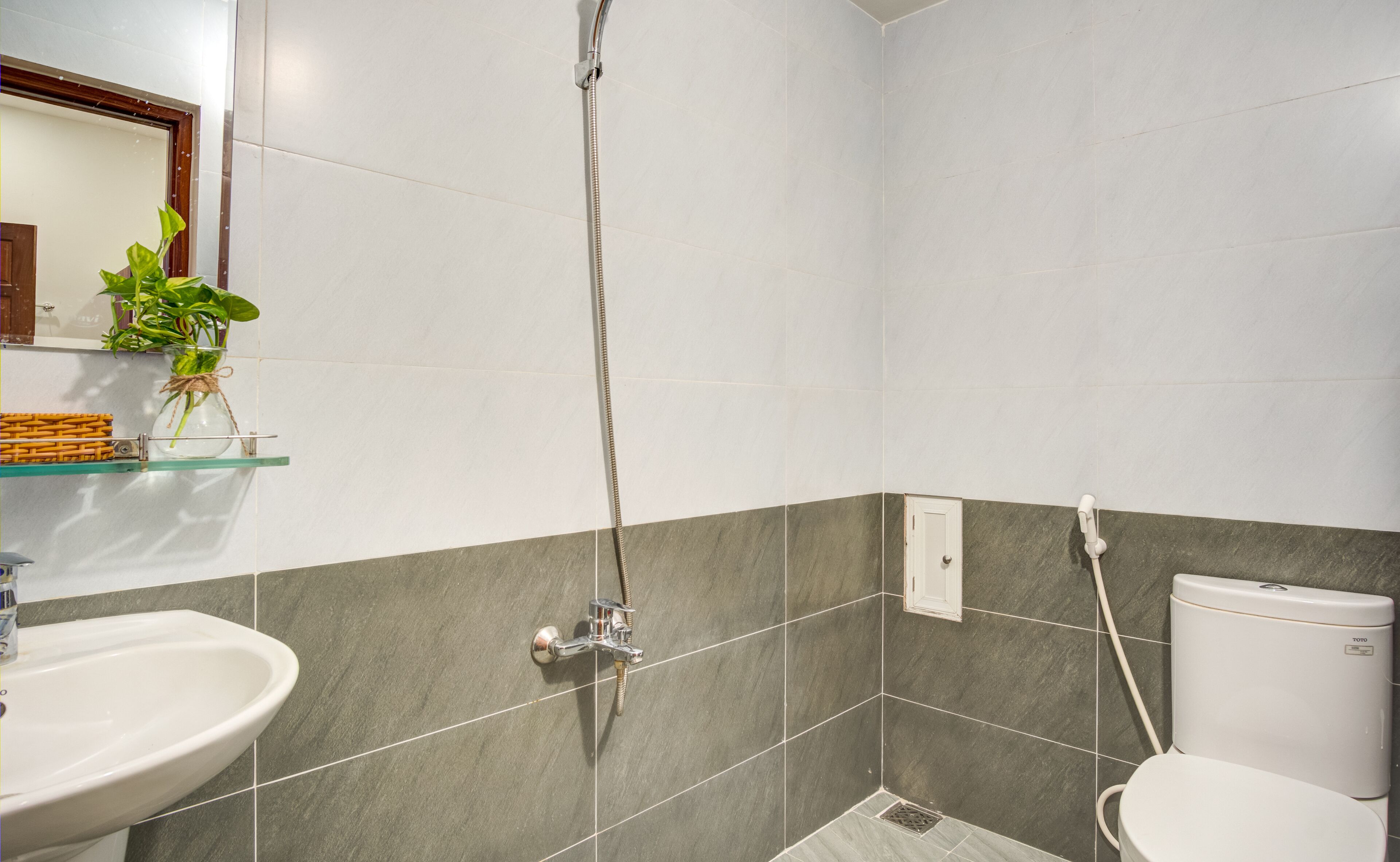 A bathroom with a shower, sink, and toilet.