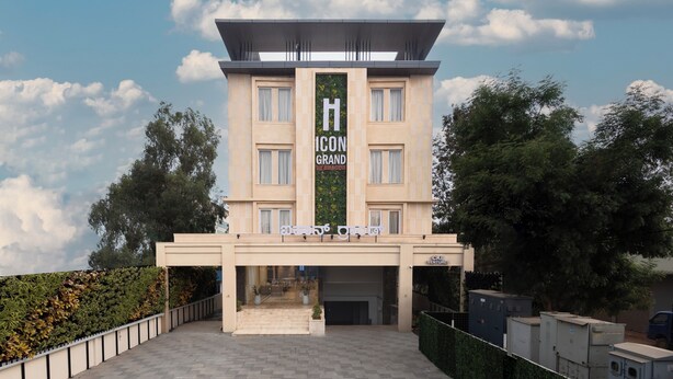 A hotel with a prominent 'H' icon sign, a modern facade, and a covered entrance. - Icon Grand Hotel by Bhagini (Bengaluru)