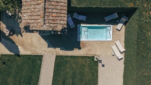 An aerial view of a property with a swimming pool, sun loungers, and a patio area. - Villa Erbaia Relais de Charme (Barberino di Mugello)