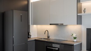 A modern kitchen with a built-in refrigerator, a sink, and a dishwasher. - Athenian Riviera Seaside Suite (Vouliagmeni)