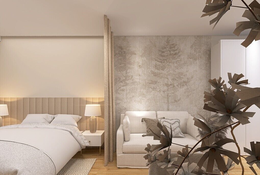 A modern bedroom with a bed, bedside tables, a sofa, and decorative foliage.