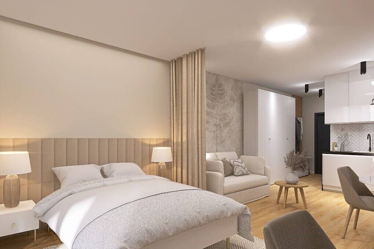 A modern hotel room with a large bed, a sofa, a dining area, and a kitchen.