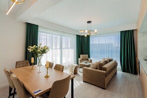 Deluxe Penthouse, 2 Bedrooms, Partial Sea View | Living area | 100-cm LED TV with cable channels, heated floors