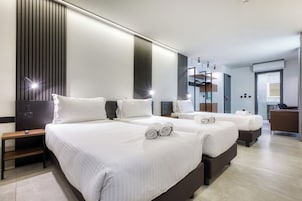 Family Triple Room | Minibar, in-room safe, desk, laptop workspace