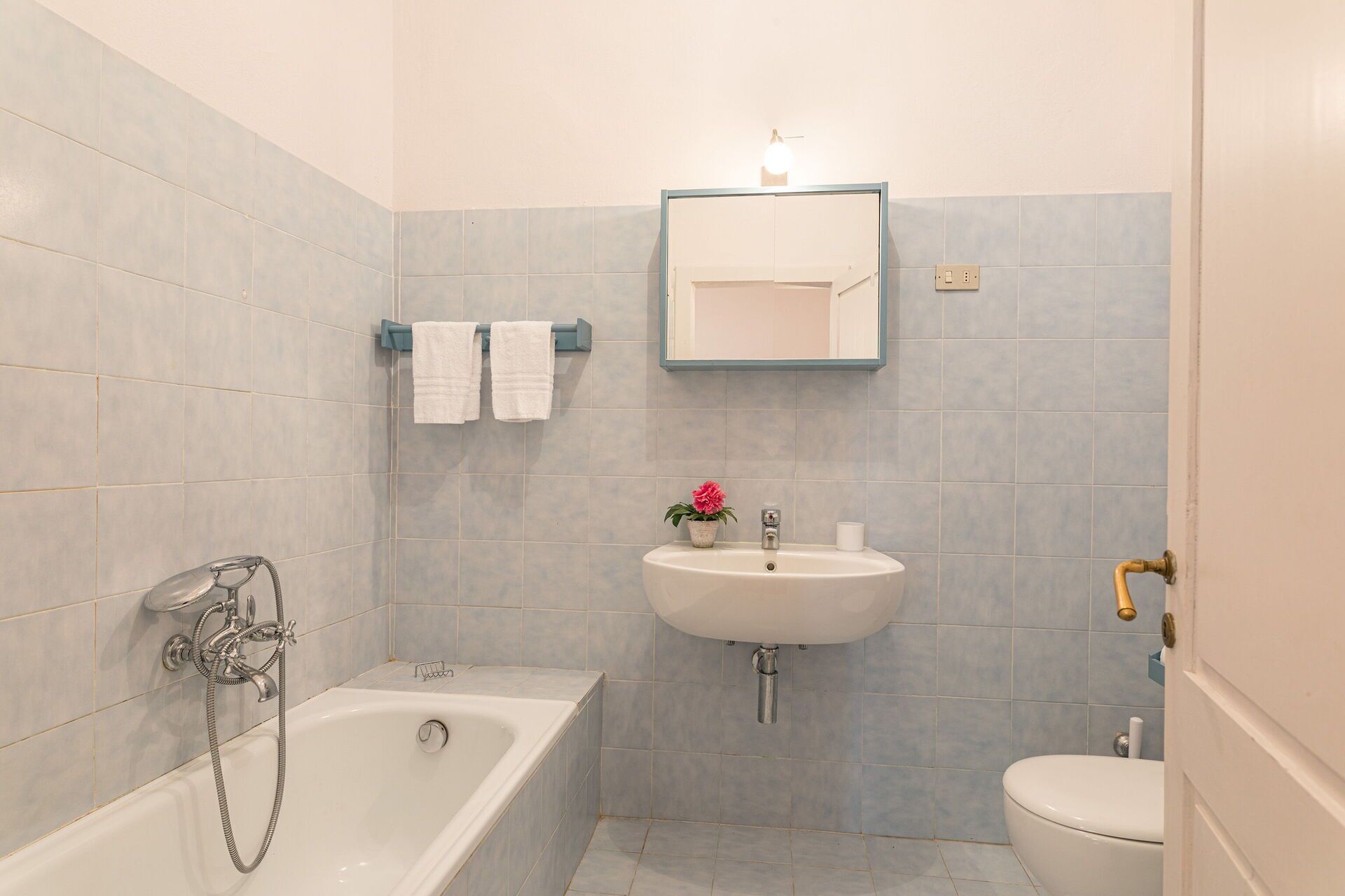 A bathroom with a bathtub, sink, and toilet.