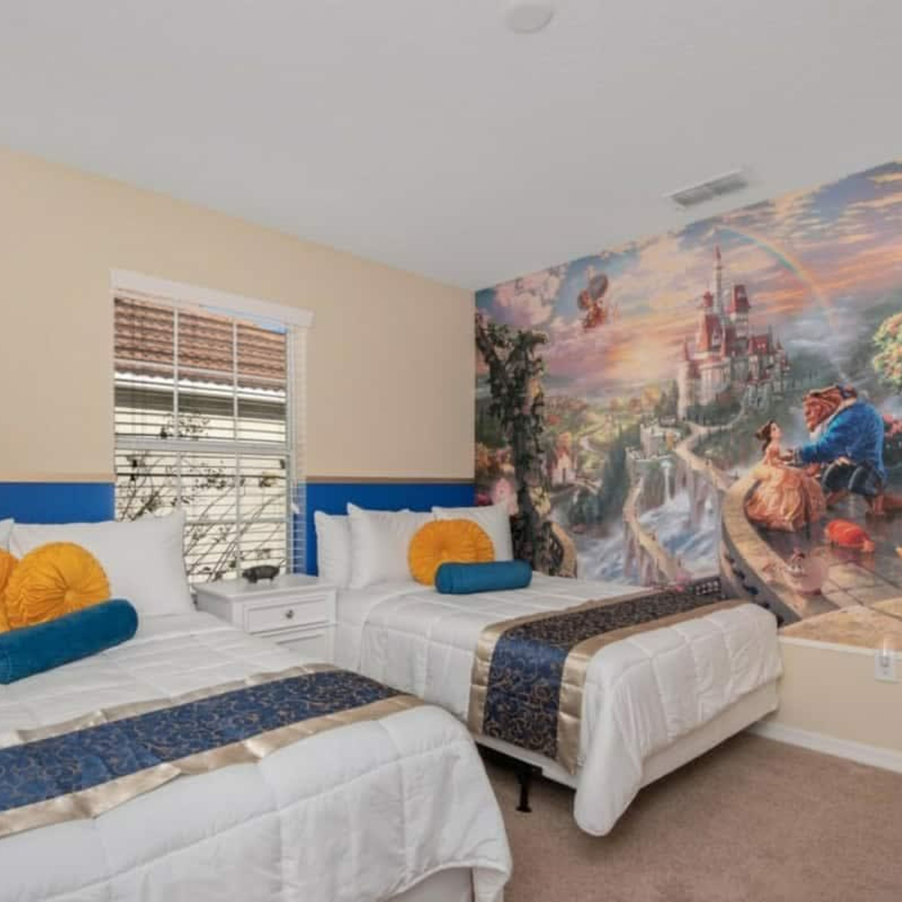 A bedroom with two beds, a large mural on the wall, and a window with blinds.