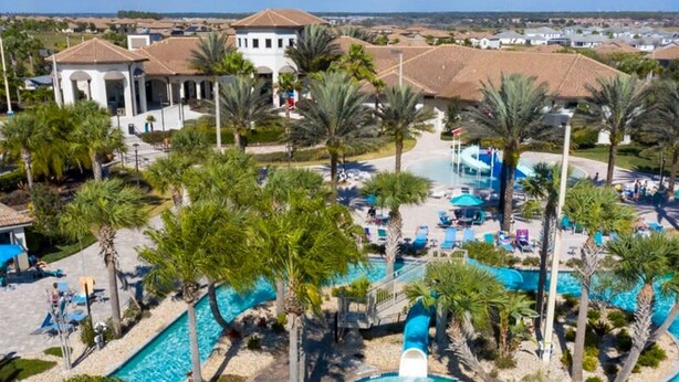 A resort with multiple swimming pools, palm trees, and a thatched-roof structure. - 1400 Stunning 8BD With Amazing Game Room (Davenport)