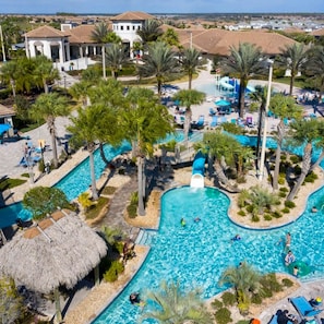 A resort with multiple swimming pools, palm trees, and a thatched-roof structure. - 1400 Stunning 8BD With Amazing Game Room (Davenport)