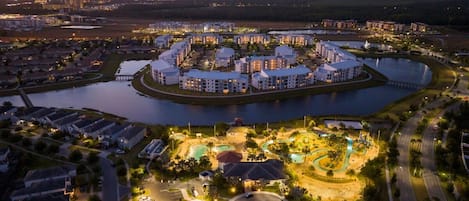 A large hotel complex with a central courtyard, multiple swimming pools, and a marina.