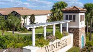 A sign for 'Windsor at Westwood' with a pool in the foreground.