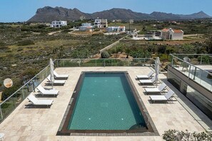 A rooftop pool with lounge chairs, surrounded by a mountainous landscape. - Tersanas Villas (Chania)