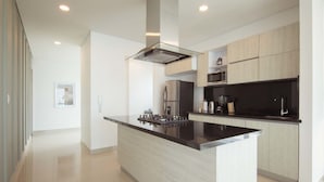 A modern kitchen with a central island, stainless steel appliances, and light wood cabinetry. - w Modern 2BR w AC in Paradisiac Cartagena (Cartagena)