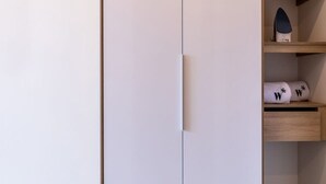 A closet with a white door, wooden shelves, and a small wooden drawer. - w Modern Loft in Chapinero (Bogotá)