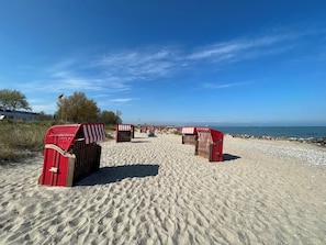 A beach with red and white striped beach huts and a clear blue sky. - Schwalbennest - Family Vacation - 450 meters from the sea - Unobstructed view (Brodersby)
