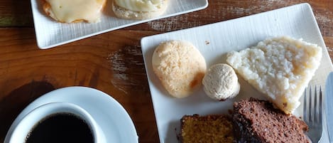 A breakfast plate with eggs, toast, and a fruit bowl.