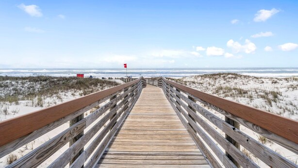 A wooden boardwalk leading to a beach with dunes and a clear sky. - Royal Gulf Beach & Racquet Club 5313 (Gulf Shores)