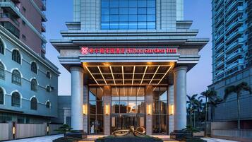 Experience the grand entrance of this elegant hotel, featuring a classical facade with large columns and a central entrance.