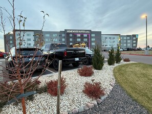 A parking lot with a hotel named "HOMEWOOD SUITES by Hilton" in the background. - Homewood Suites By Hilton Colorado Springs Airport (Colorado Springs)