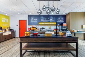 A breakfast area with a counter, coffee machines, and a chalkboard menu. - Hampton Inn By Hilton Ocoee Orlando (Ocoee)
