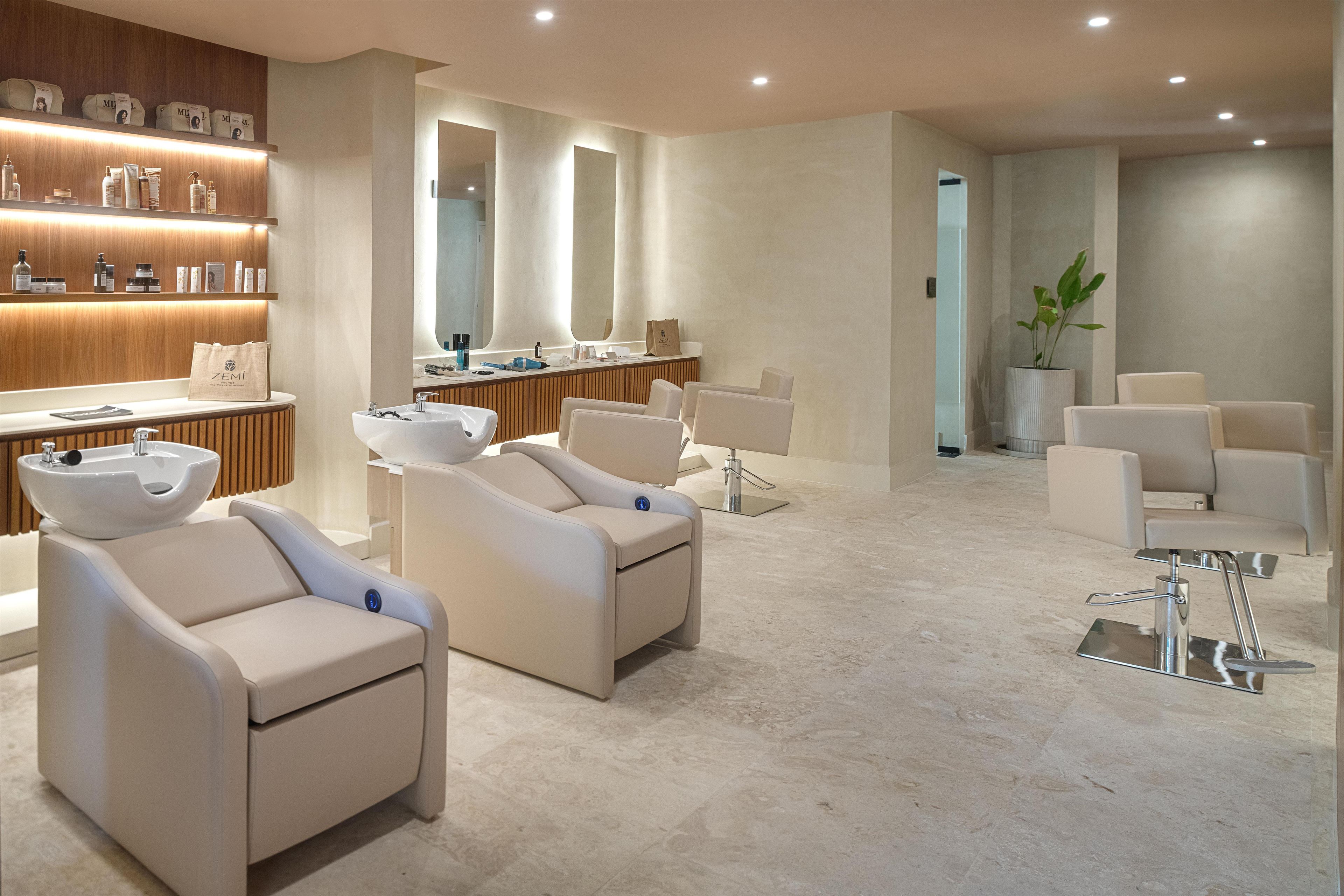 A modern spa with a reception desk, seating area, and a large mirror.