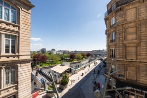 A street view with buildings, a pedestrian walkway, and a clear sky. - Hôtel Bristol Nord (Paris)