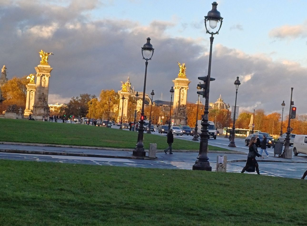 A park with statues and lampposts.