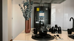 A modern kitchen with a central island, a built-in oven, and a stainless steel range hood.