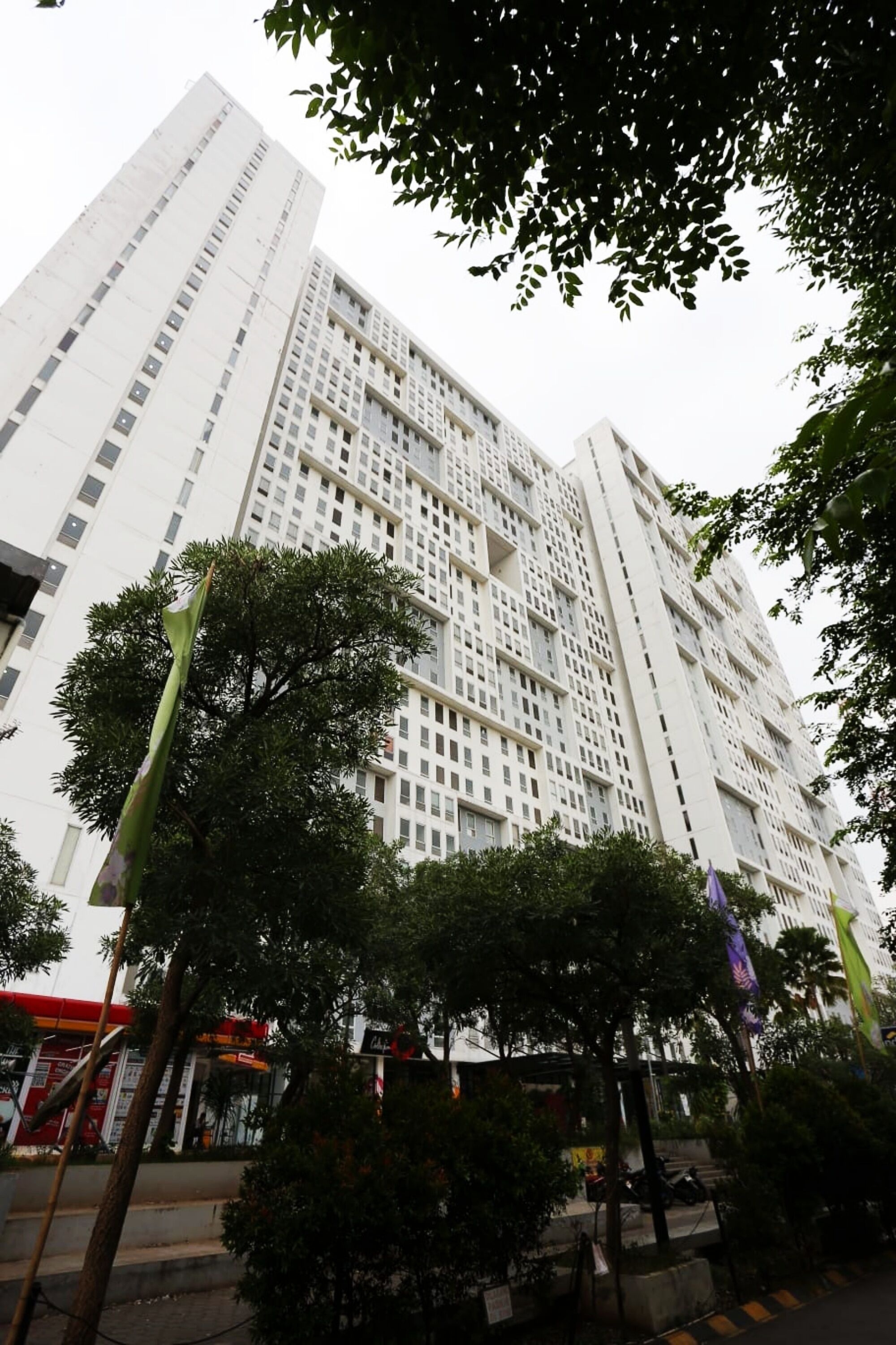 A tall, modern building with a grid-like facade and multiple windows.