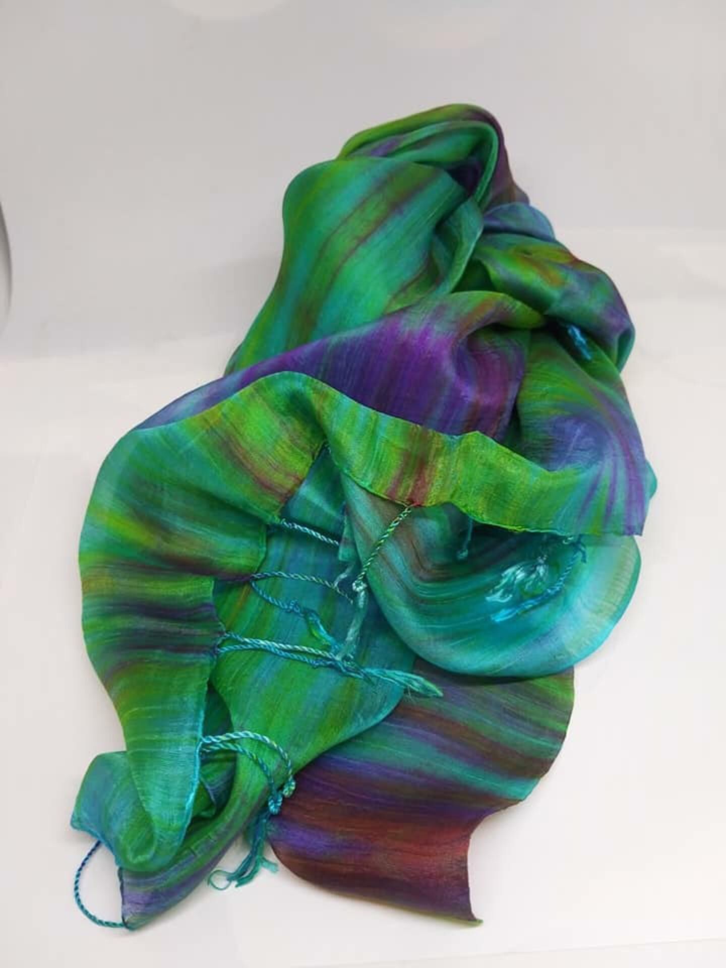 A fabric with a mix of green and purple hues.