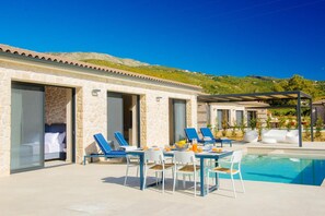 Relax by the pool, enjoy meals at the outdoor dining area, or unwind in the seating area with lounge chairs.