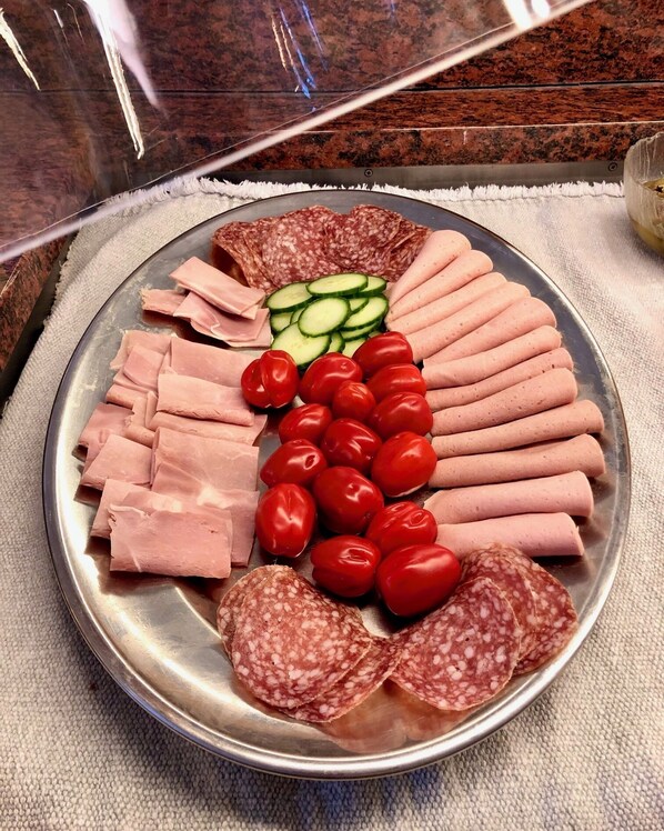 A platter with various meats and vegetables.