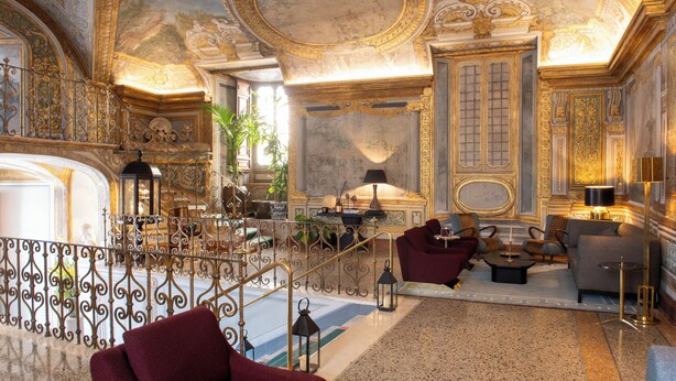 A luxurious interior with ornate ceiling, a grand staircase, and elegant furnishings. - Palazzo Shedir - The Leading Hotels of the World (Rome)