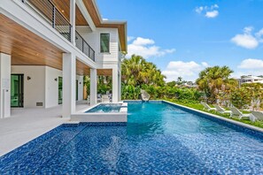 Enjoy a refreshing swim in the large pool surrounded by lush greenery.