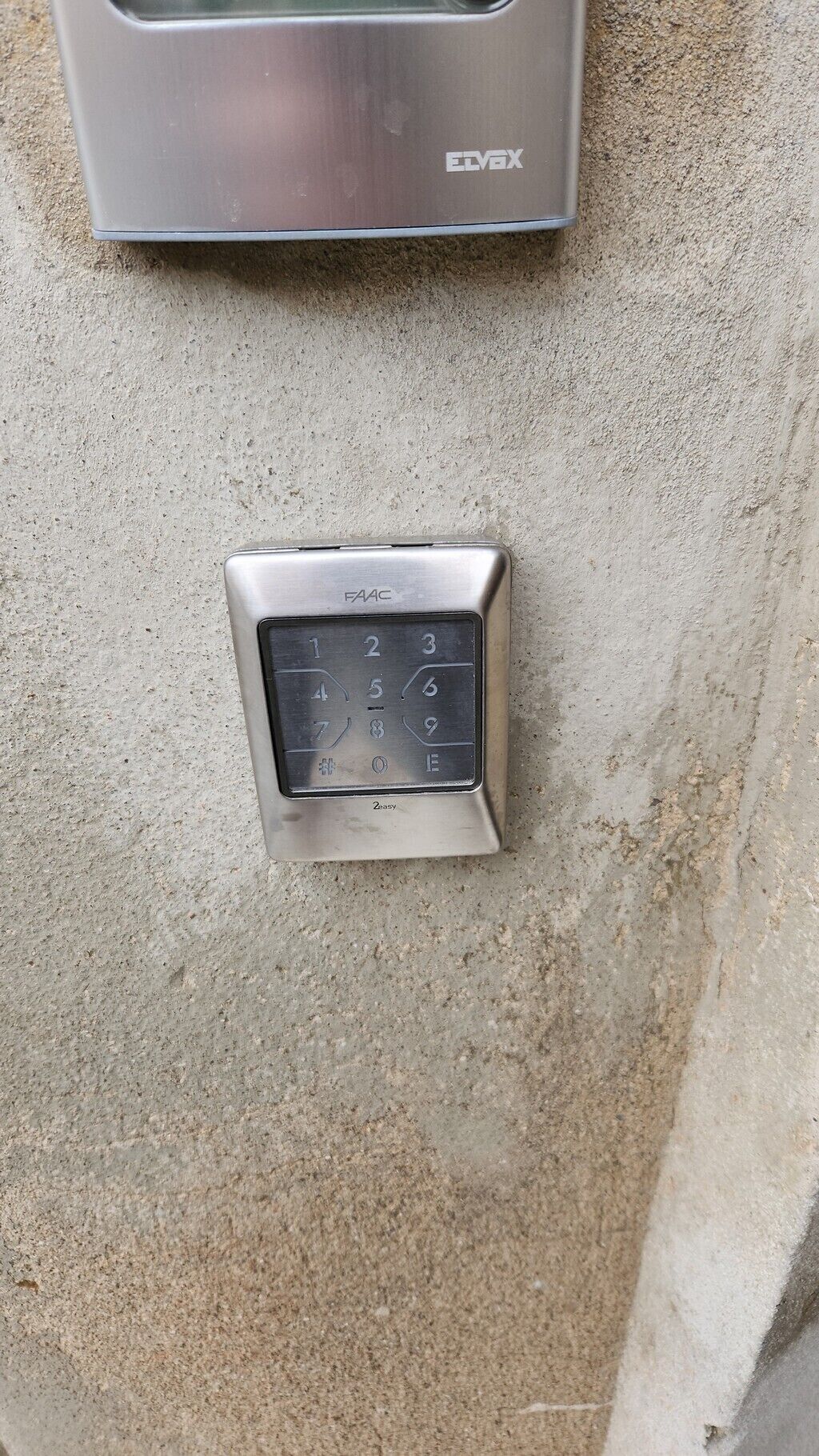 A keypad lock installed on a concrete surface, likely for security purposes.