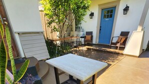 An outdoor patio with wicker furniture, a table, and chairs. - Luxury 2 bed 1 bath in nice neighborhood. (Torrance)