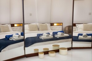 A hotel room with a large bed, multiple pillows, and neatly folded towels.