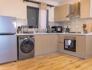 Compact kitchen with appliances and storage for a functional living space.