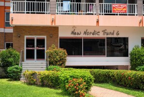 New Nordic Trend 6 features a brick facade with a white upper section and a balcony with a railing.