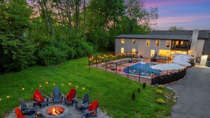 A backyard with a fire pit, outdoor seating, a swimming pool, and a covered patio area. - Estate: Heated Pool, Hot Tub, Game Rooms, Pets (La Grange)