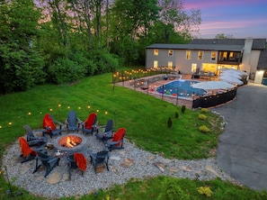 A backyard with a fire pit, outdoor seating, a swimming pool, and a covered patio area. - 3.7 Acre Estate w/ Heated Pool, 5 Kings-2 Game Rms (La Grange)