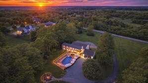 A large house with a swimming pool, surrounded by trees and a well-maintained lawn. - Estate: Heated Pool, Hot Tub, Game Rooms, Pets (La Grange)