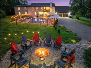 A backyard with a fire pit, outdoor seating, and a pool area. - Estate: Heated Pool, Hot Tub, Game Rooms, Pets (La Grange)