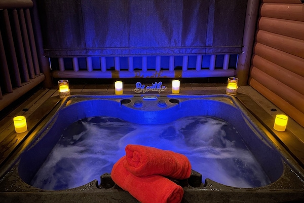 Recessed hot tub on private screened in front porch with privacy blinds