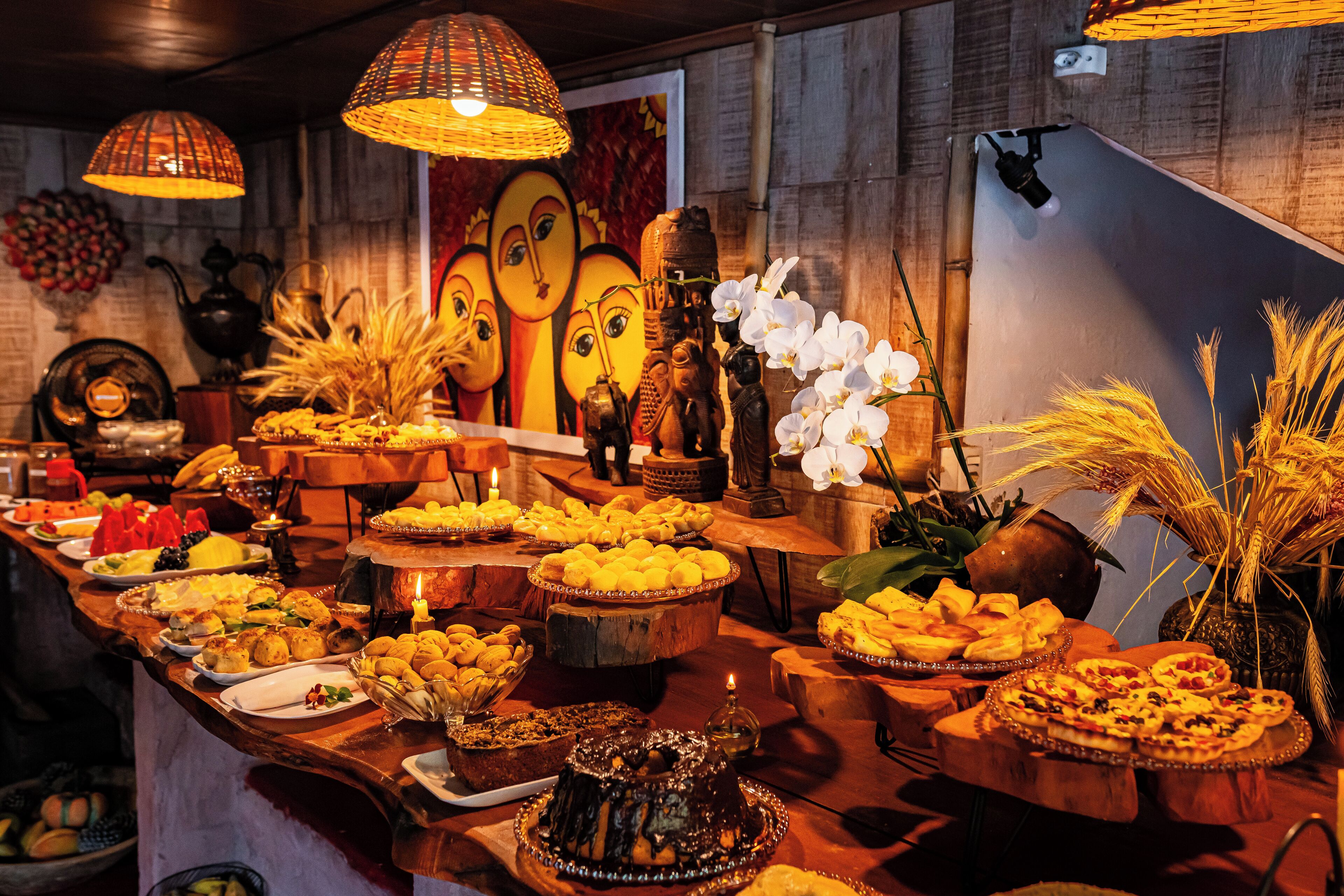 A buffet table with various food items and decorative elements.