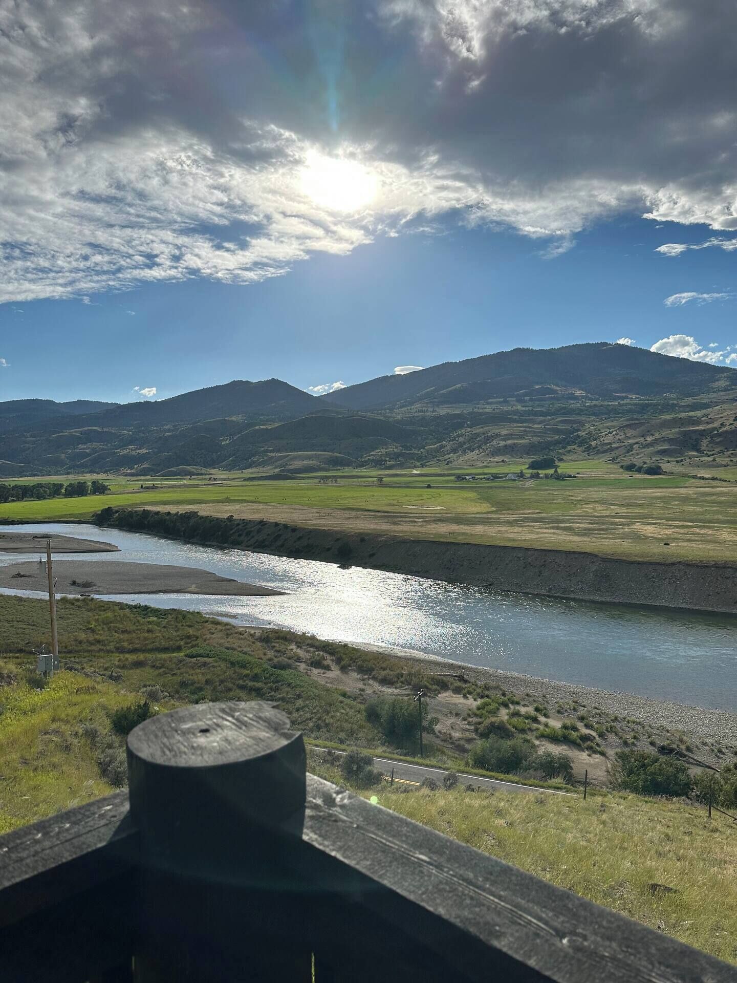 A river flowing through a valley with mountains in the background.