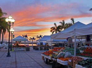 An outdoor market with tents and stalls selling produce, set against a sunset sky. - 8BD Ft Pierce Beach Getaway - Great for Family Group (Fort Pierce)