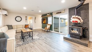 A modern living room with a sofa, coffee table, and a fireplace.
