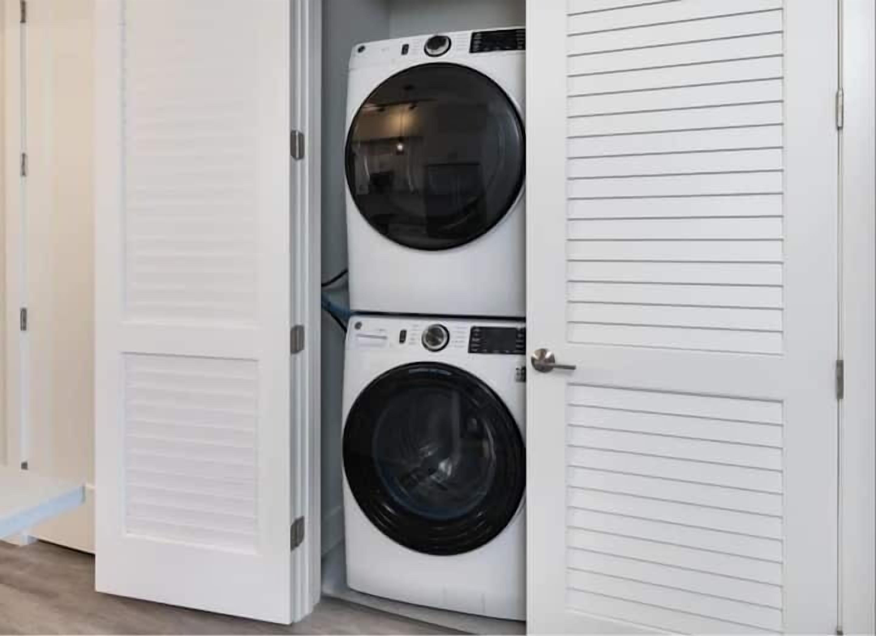 A laundry room with two stacked front-loading washing machines.