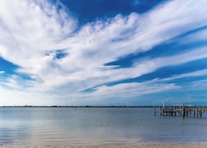A calm lake with a wooden pier extending into the water.
